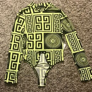 Green and black bodysuit with designs.